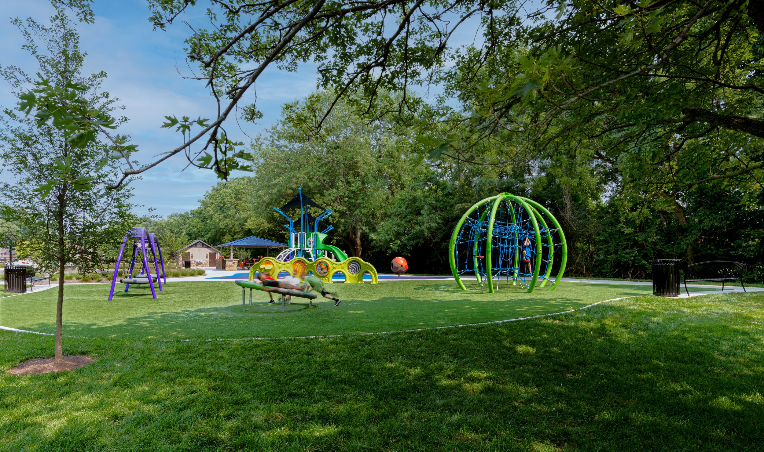 A photography of a playground in green open spaces.