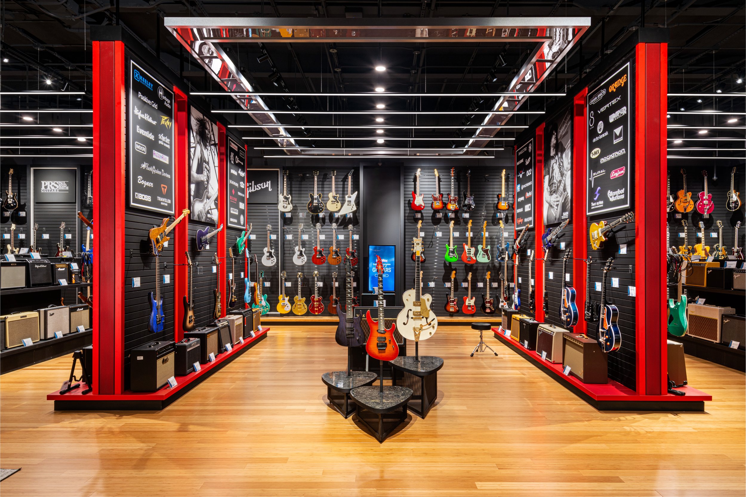 Interior photography of lots of colorful electric guitars in a music shop in Indiana.