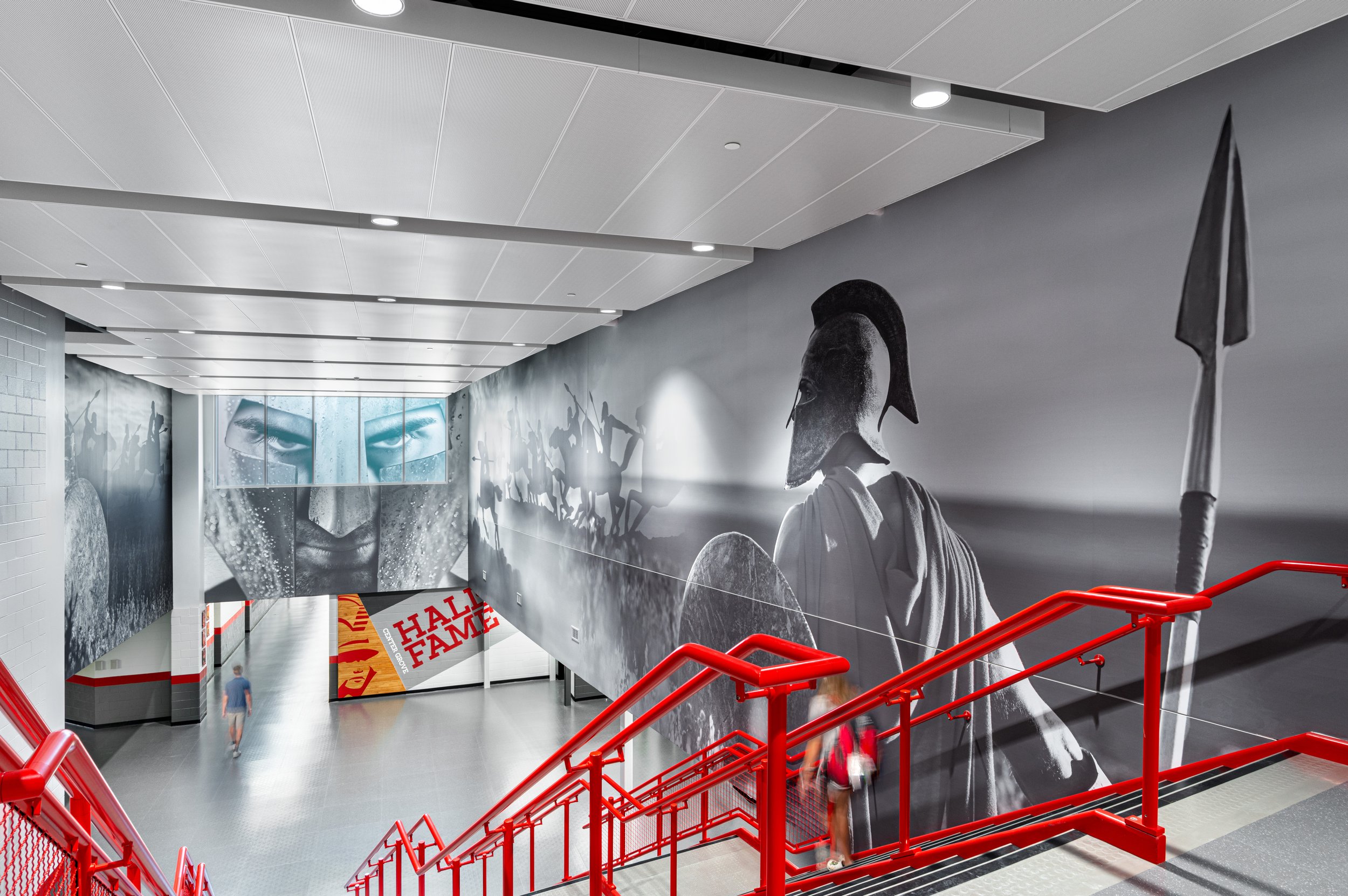 An architectural interior photography of a hall with photos of a Greek warrior.
