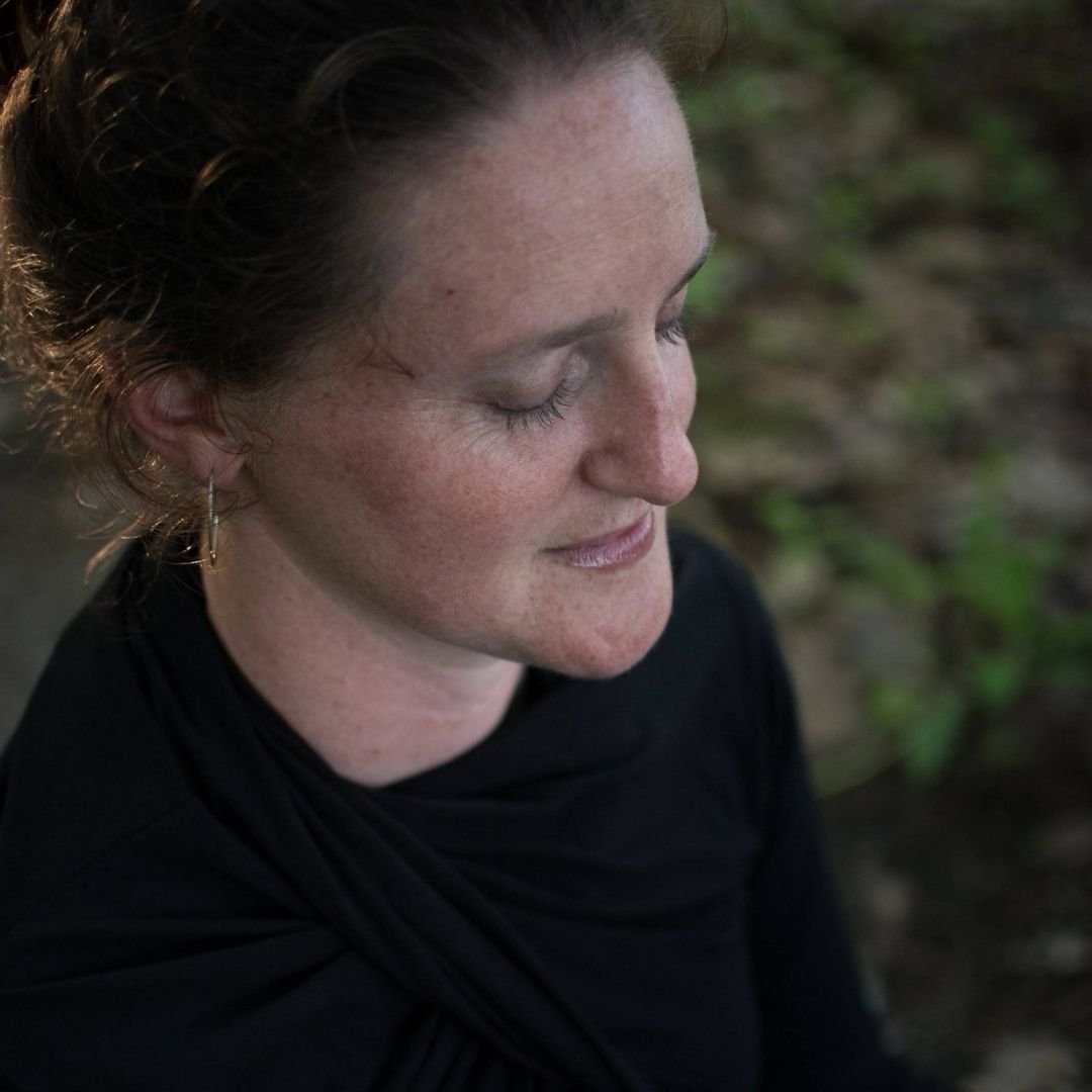 Woman meditating in forest