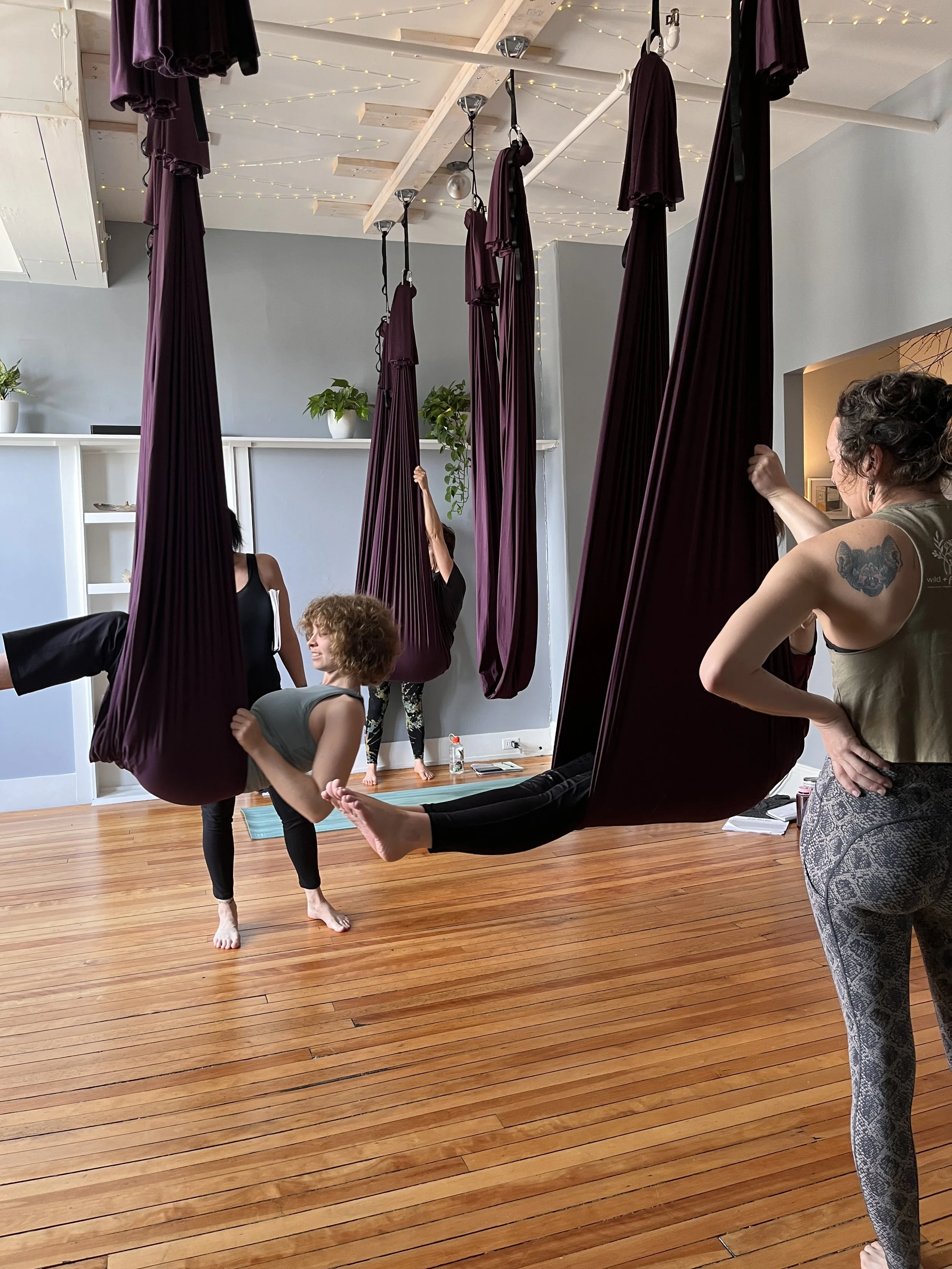 students taking aerial yoga teacher training in Brunswick Maine yoga studio