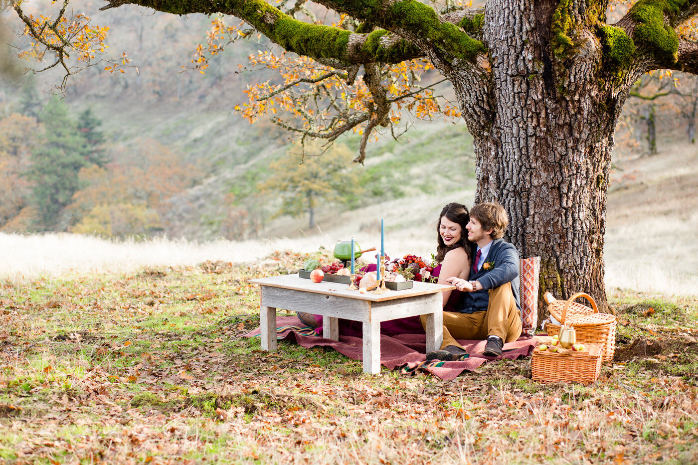 Eloping couple in beautiful outdoor setting with picnic spread