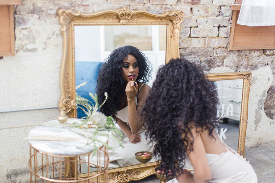 Gorgeous black bride looking in mirror