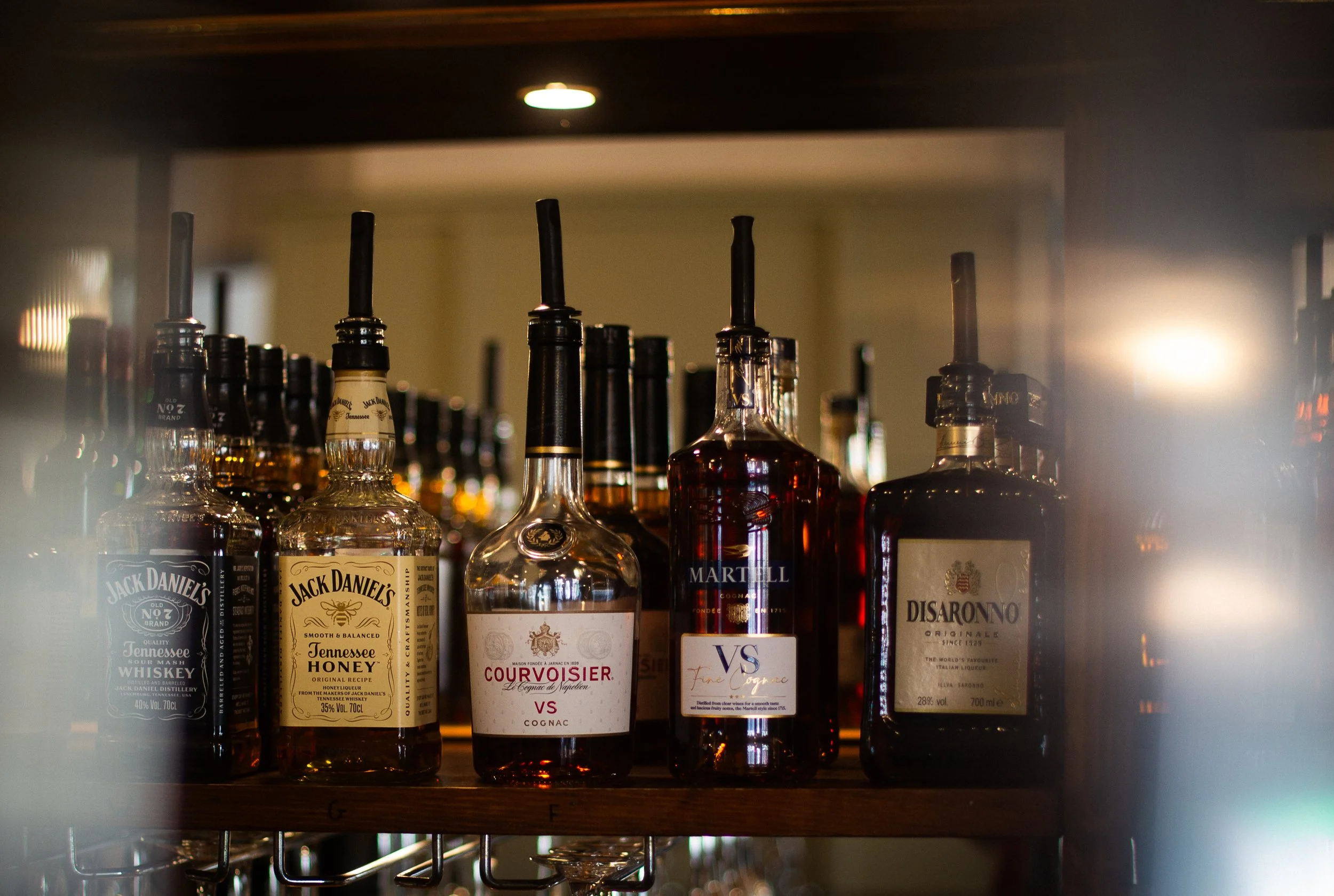 Shelf displaying a selection of bottles of spirits