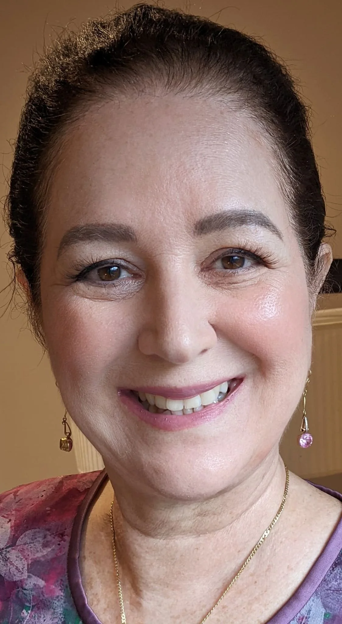 Mother of the bride smiling with her makeup done