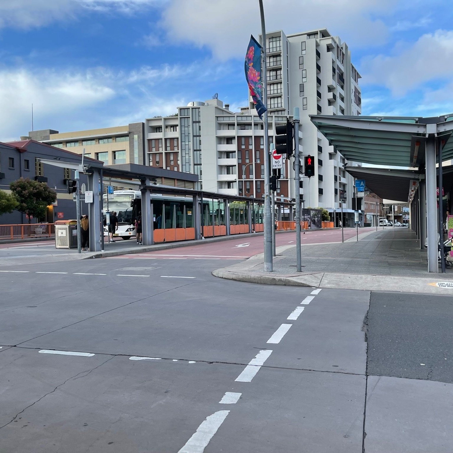 Cross the road and continue through the bus interchange