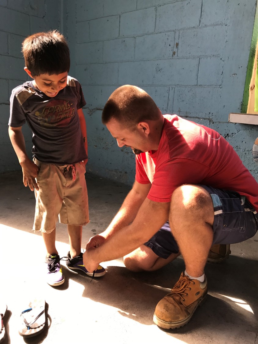 A pair of shoes given to a boy with a smile.