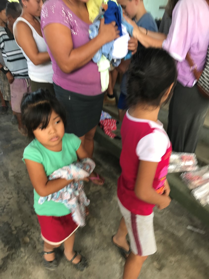 Passing out clothes to impoverished families