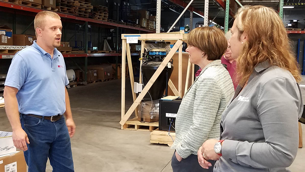 Production Supervisor Jordan Honnette greets Sen. Klobuchar as the tour reaches Kahler Automation’s production area.