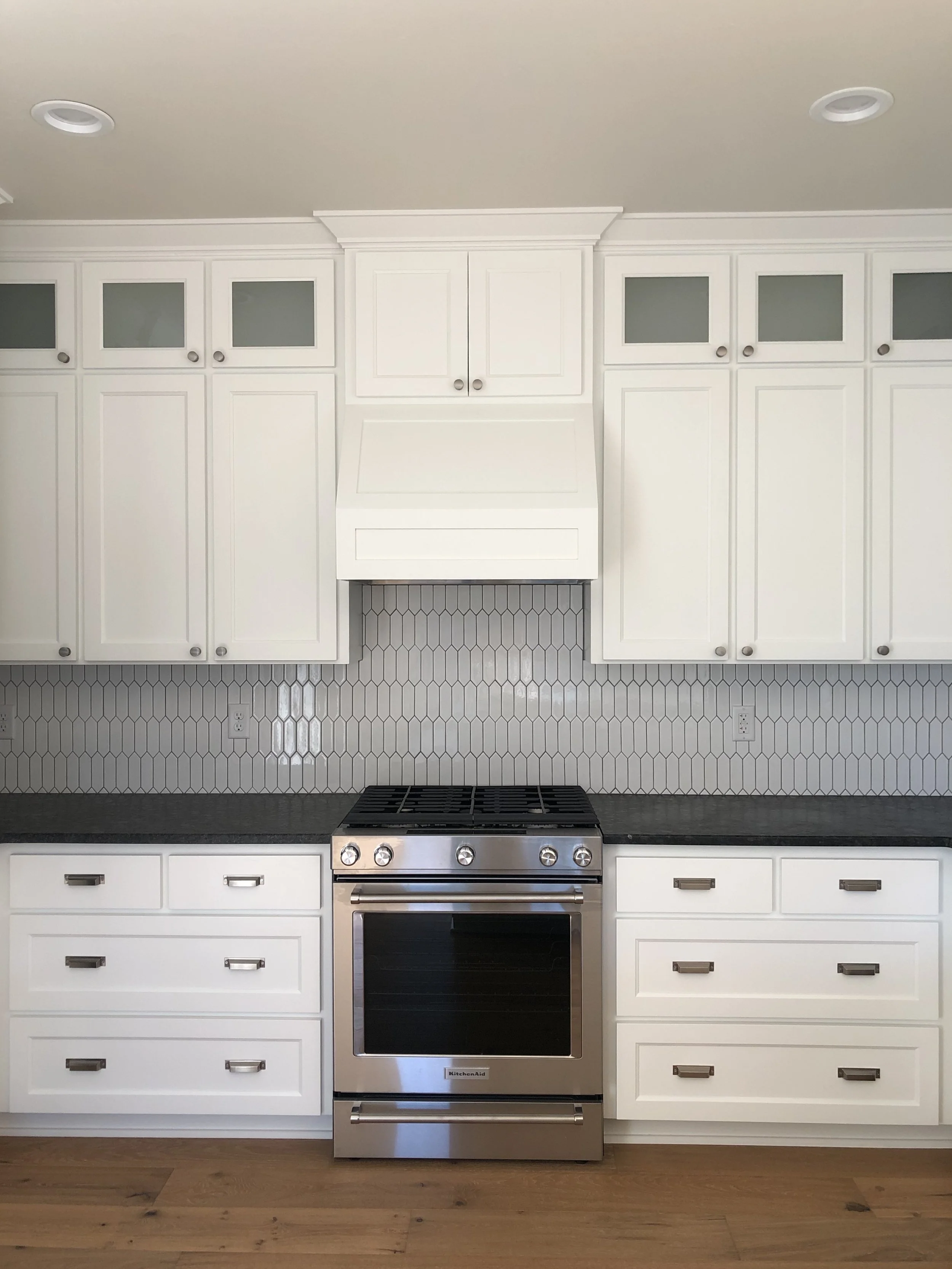 The kitchen cabinets extend all the way to the ceiling with additional storage.