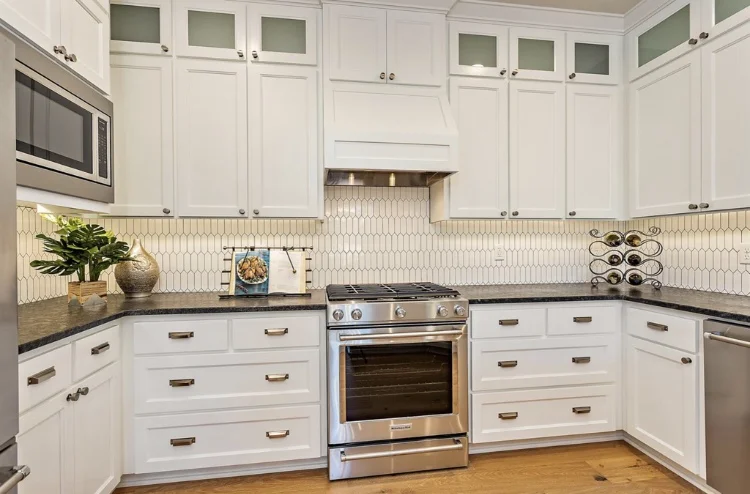 The brushed nickel cabinet and drawer pulls create a traditional and yet modern feel. The long, flat hex backsplash adds character and visual interest and yet doesn’t compete with the rest of the kitchen details.