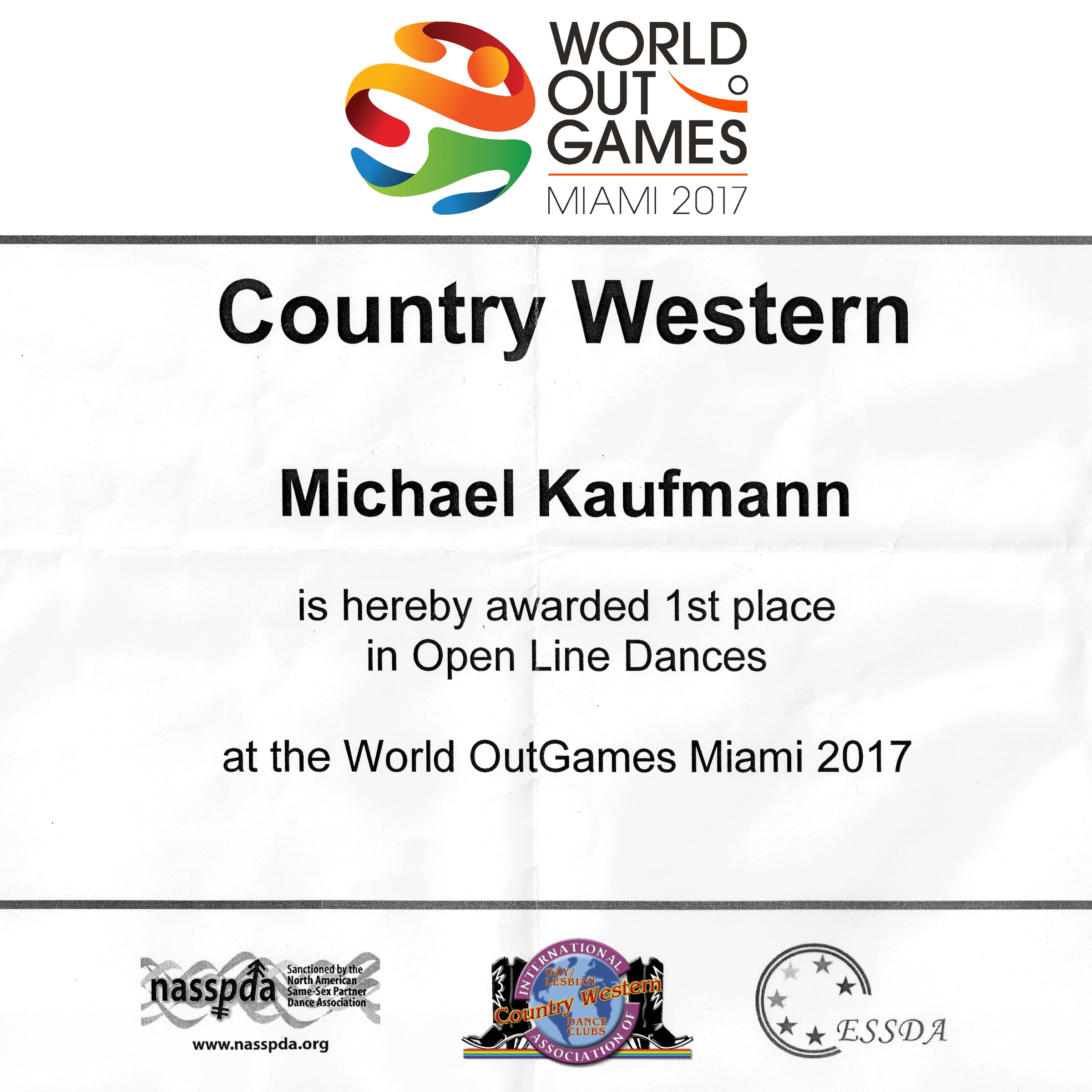 Michael Kaufmann was awarded 1st place in Open Line Dances for the Country Western dancesport event at the World OutGames Miami 2017 .