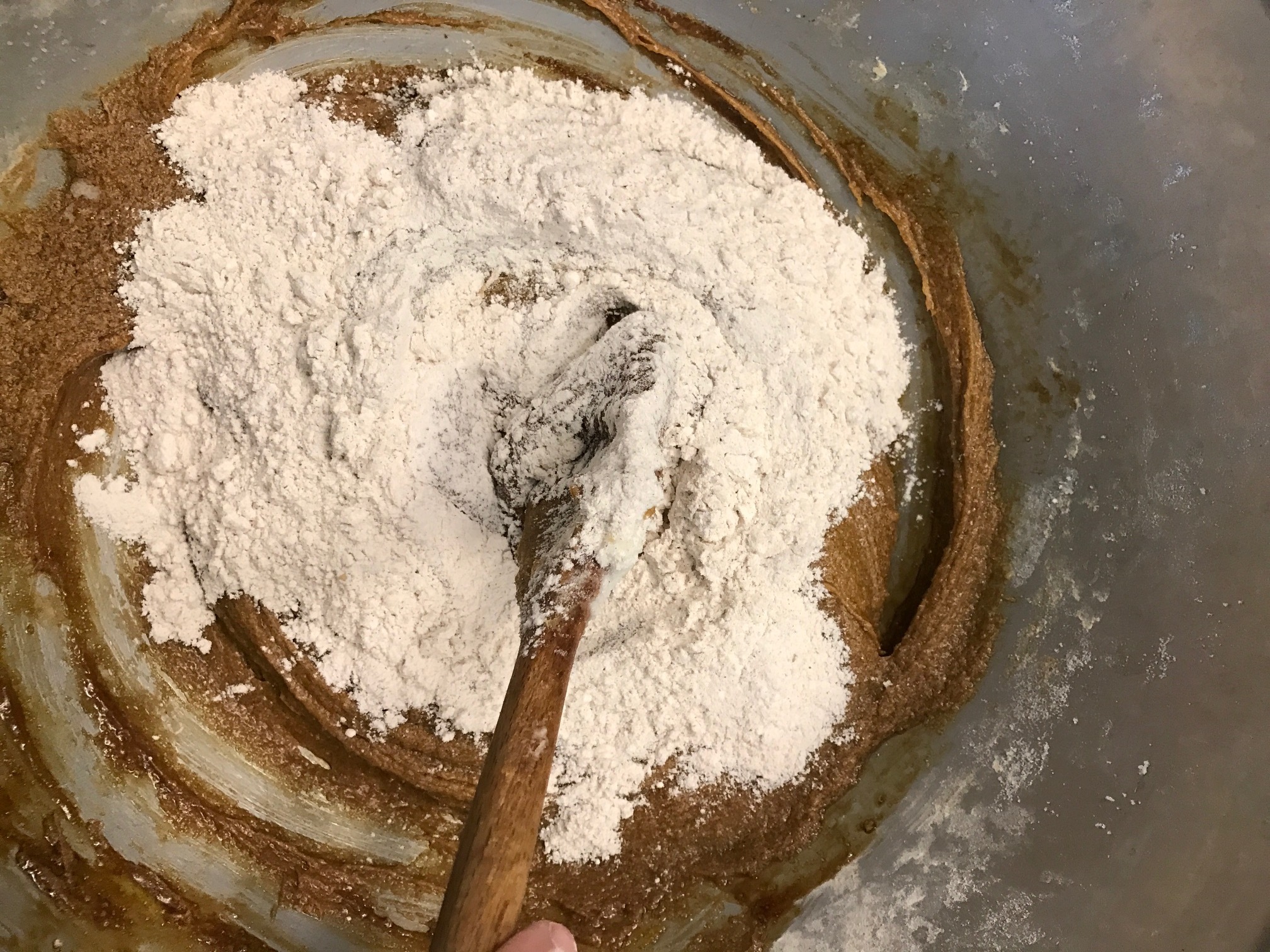 Gradually incorporate dry ingredients into the creamed mixture. 