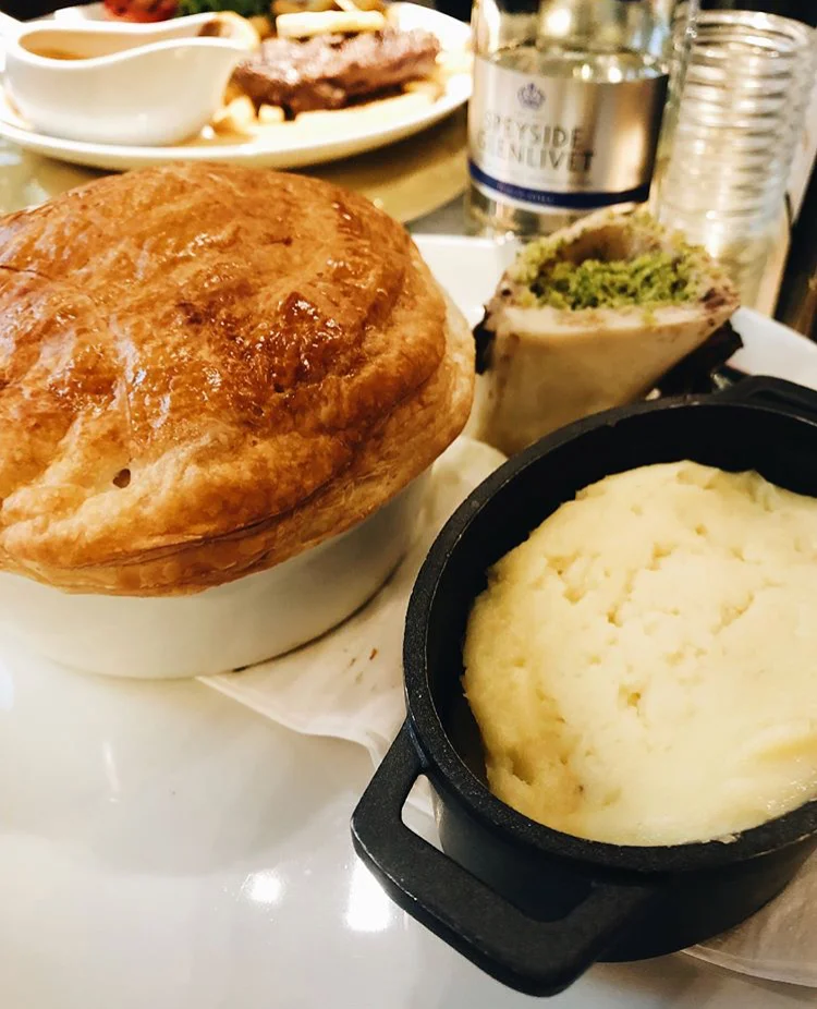 Pie and Mash | London, England Fluffy and hardy pie was very filling lightly baked on the outside with vegetables and steak on the inside.