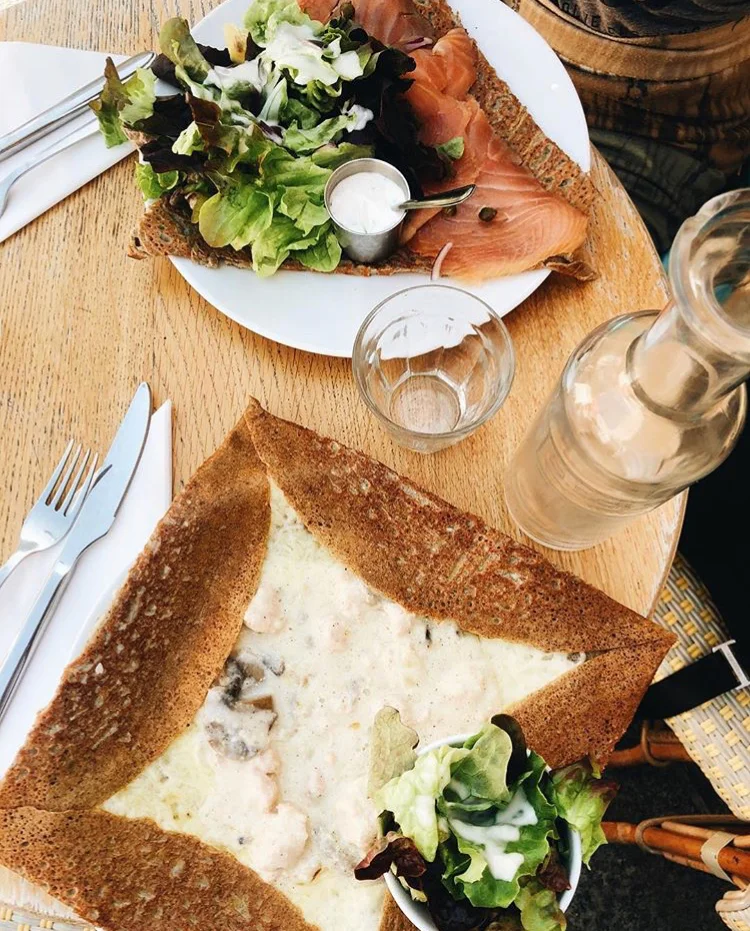 Crepe | Paris, France Thin pancake with toppings in the inside. Most people think of dessert crepes, but the one pictured is an open face savory crepe with chicken mushroom and crème sauce.