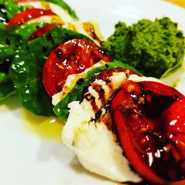 Tomato, basil, mozzarella with a little pesto drizzled with olive oil and balsamic. Sometimes simple is best.