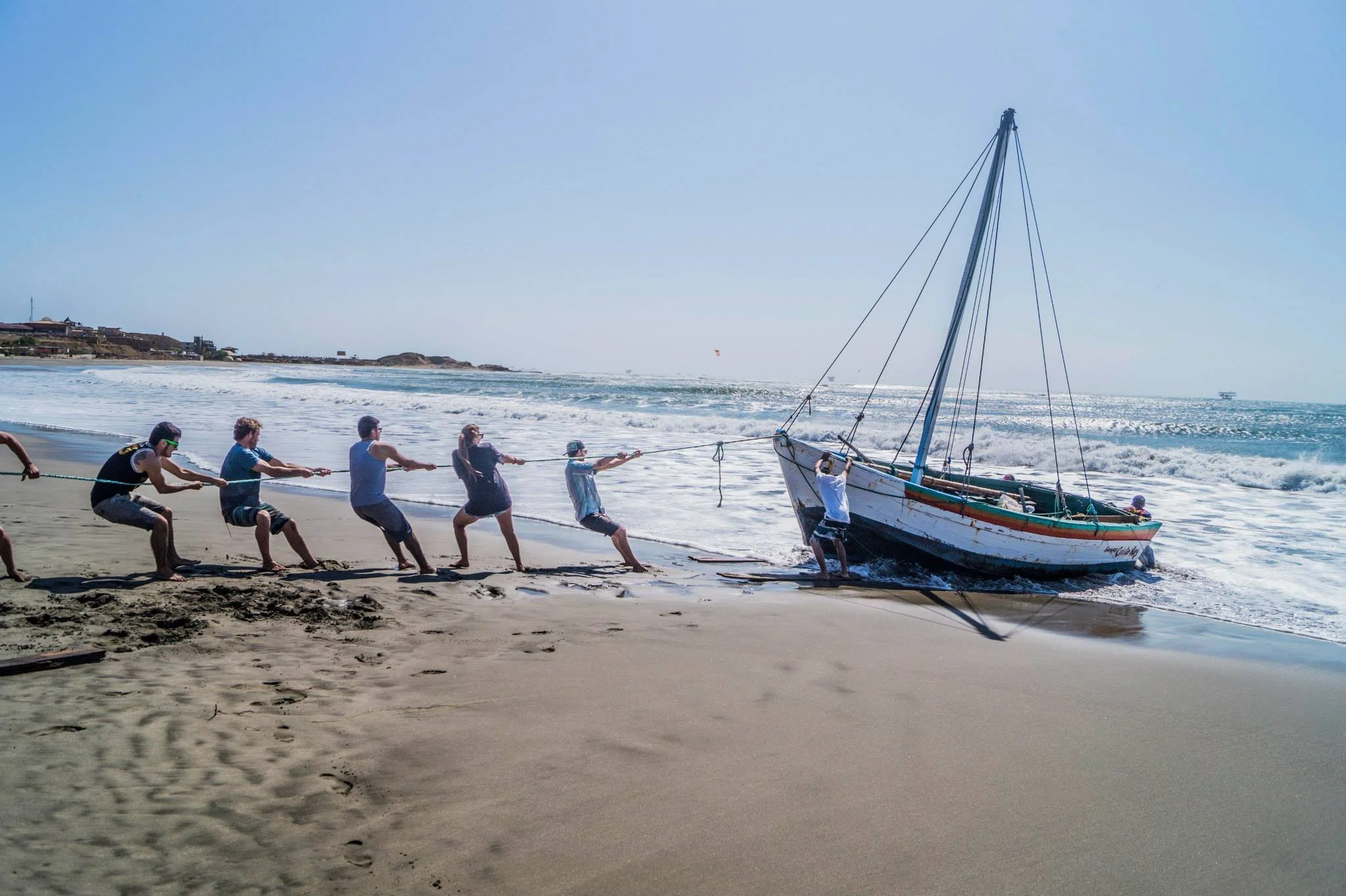 Helping Fishermen Hoist Ashore Their Broken Boat In Lobitos, Peru