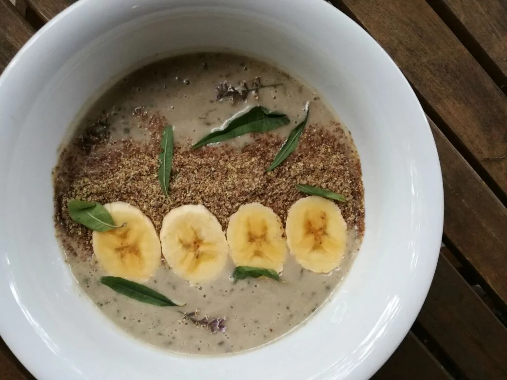 Banana and honey smoothie bowl with lemon verbena leaves