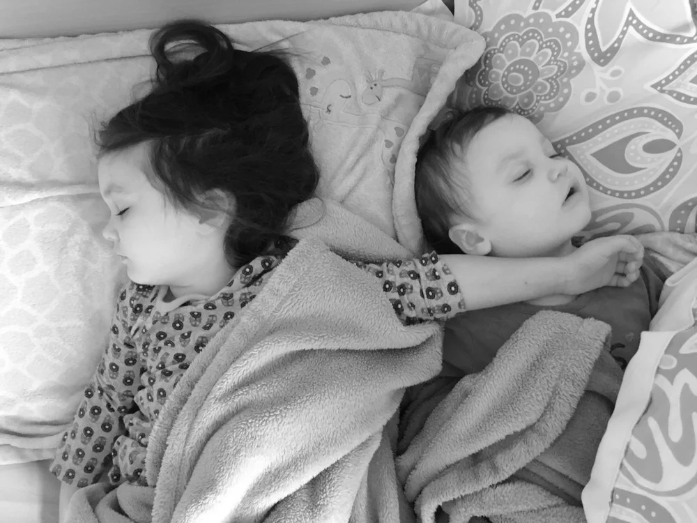 Here's a recent picture of you napping with your sister. Your arm thrown over Emerson's neck is the best. Your mom sends me pictures of you sleeping all the time and I couldn't love anything more. This particular picture reminds me of my favorite picture of your mom and me napping together when we were little. I think I was almost exactly the age you are right now.