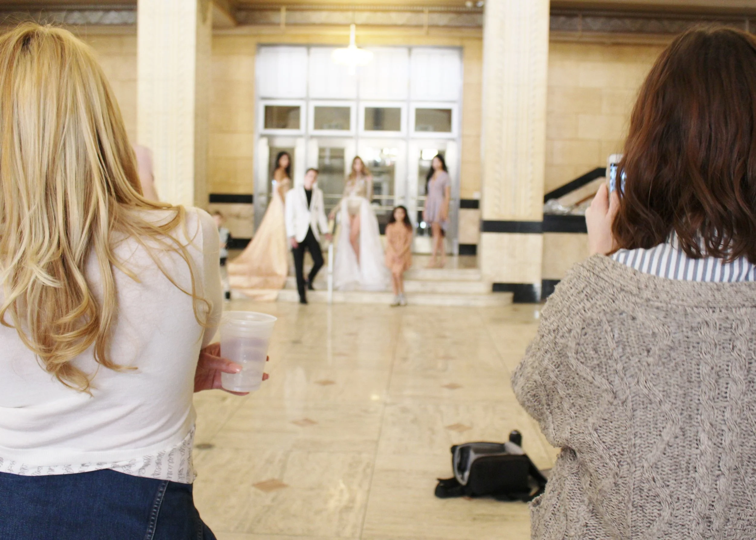 Designers Georgina Herrera and Meghann Wheelock watch from behind the scenes. 