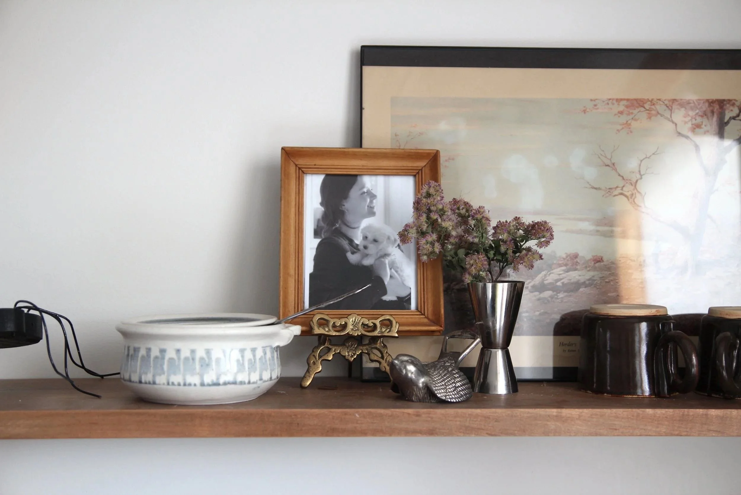 A glimpse into my daily ritual: A shelf with a favorite photo of my puppy, where the morning light creates a warm, grounded space for presence and creative reflection.