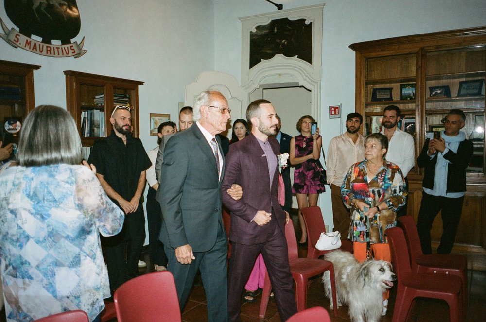 Groom walking down the aisle with his father