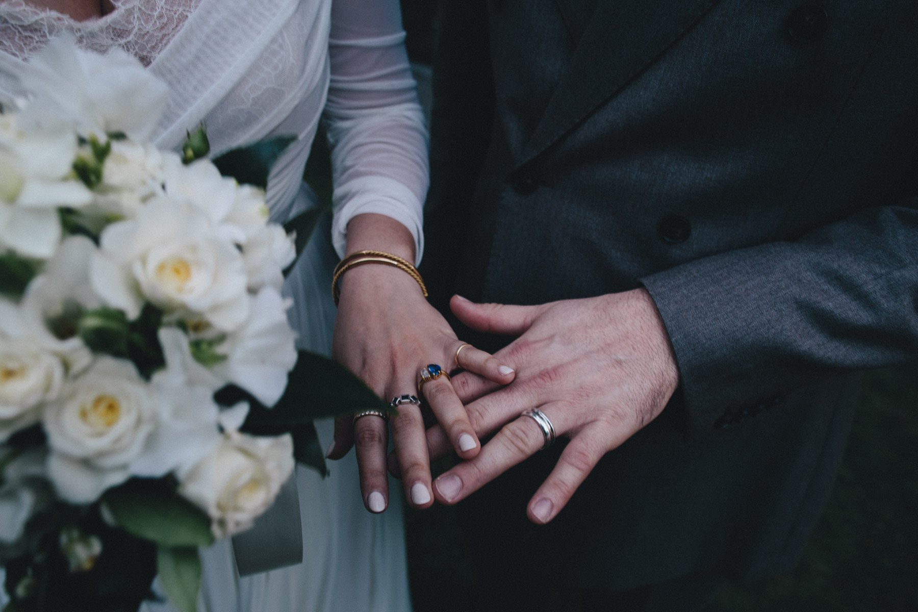 A couple's hands with their wedding rings at Haas-Lilienthal House