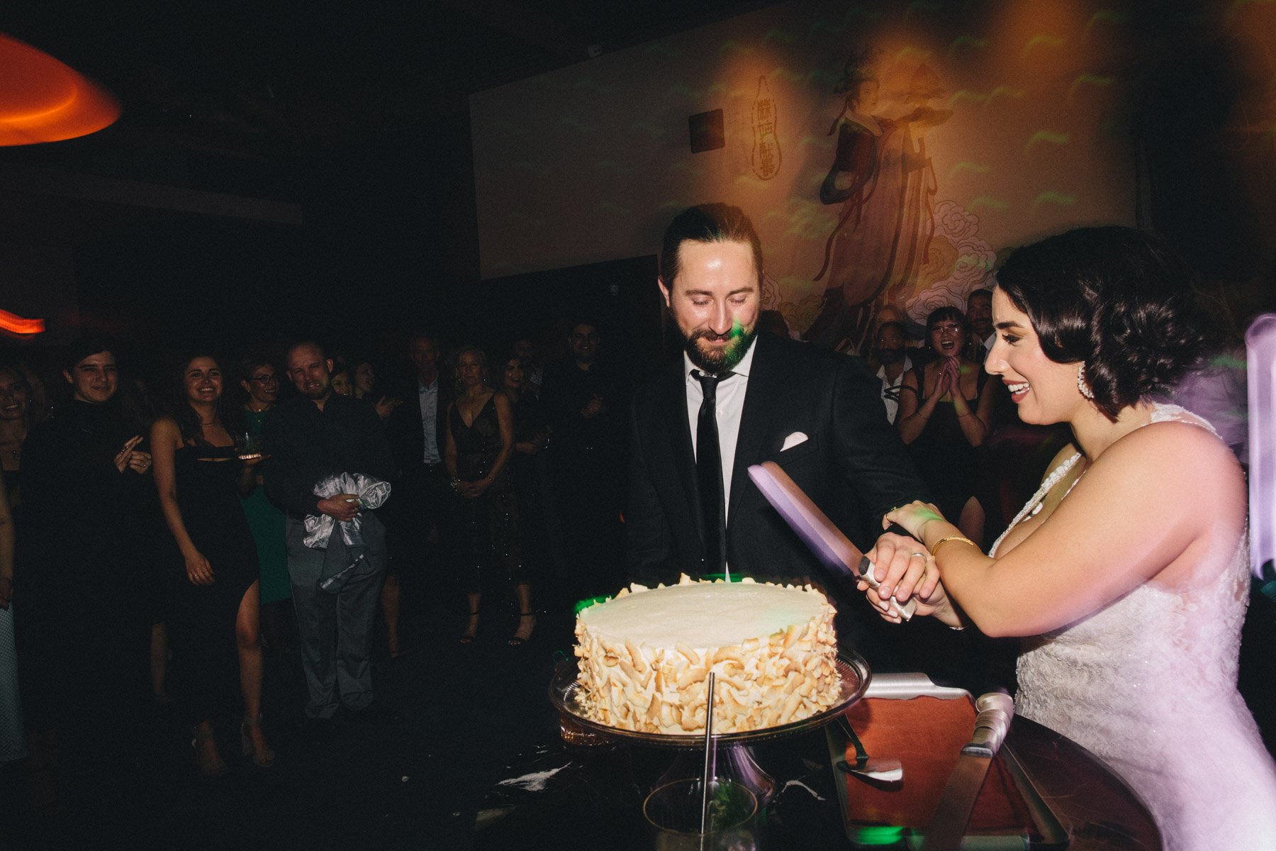 A bride and groom cutting their cake at Moongate Lounge