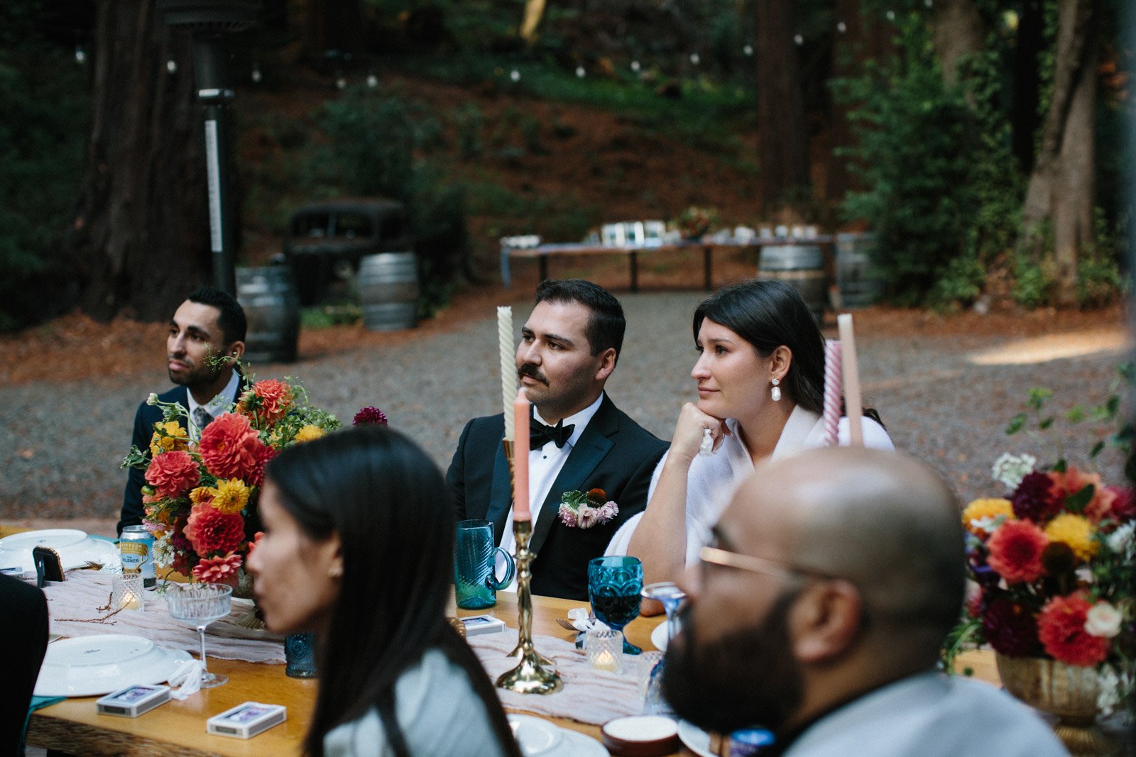 Bride and groom listening to a speech during their wedding dinner