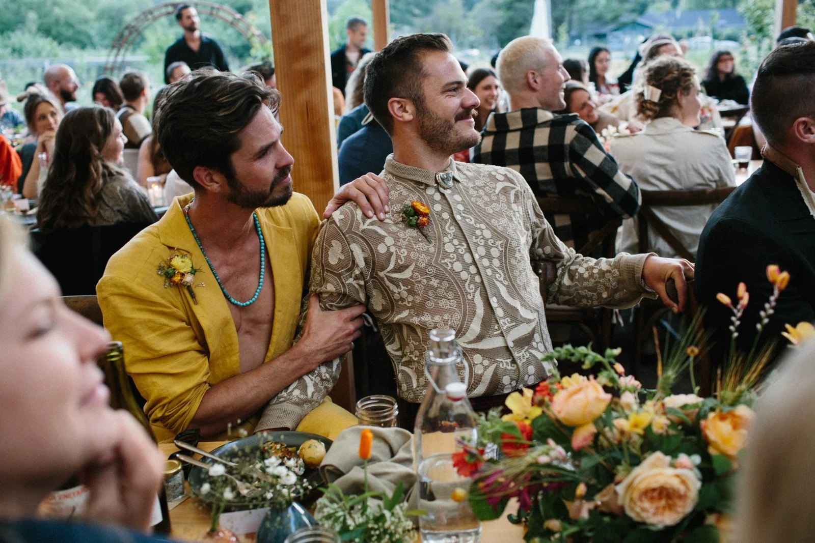 Grooms listen to wedding speeches at Solar Punk Farms
