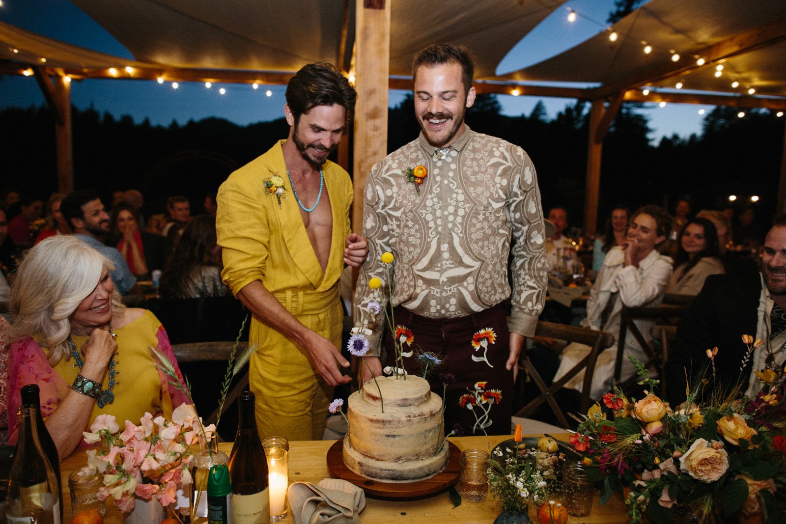 Grooms cut their wedding cake at Solar Punk Farms