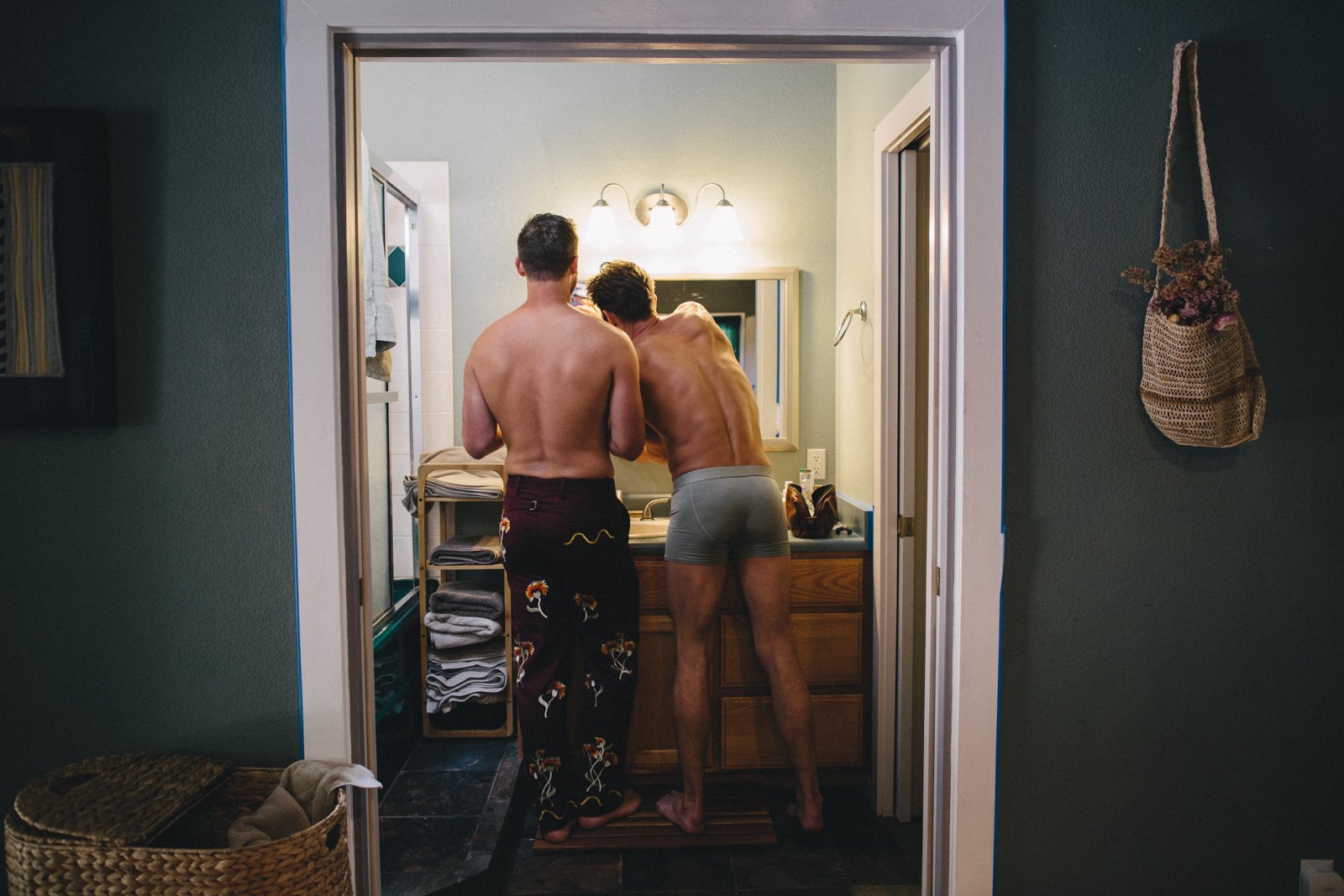 Grooms share getting ready moment at home before their Solar Punk Farms wedding