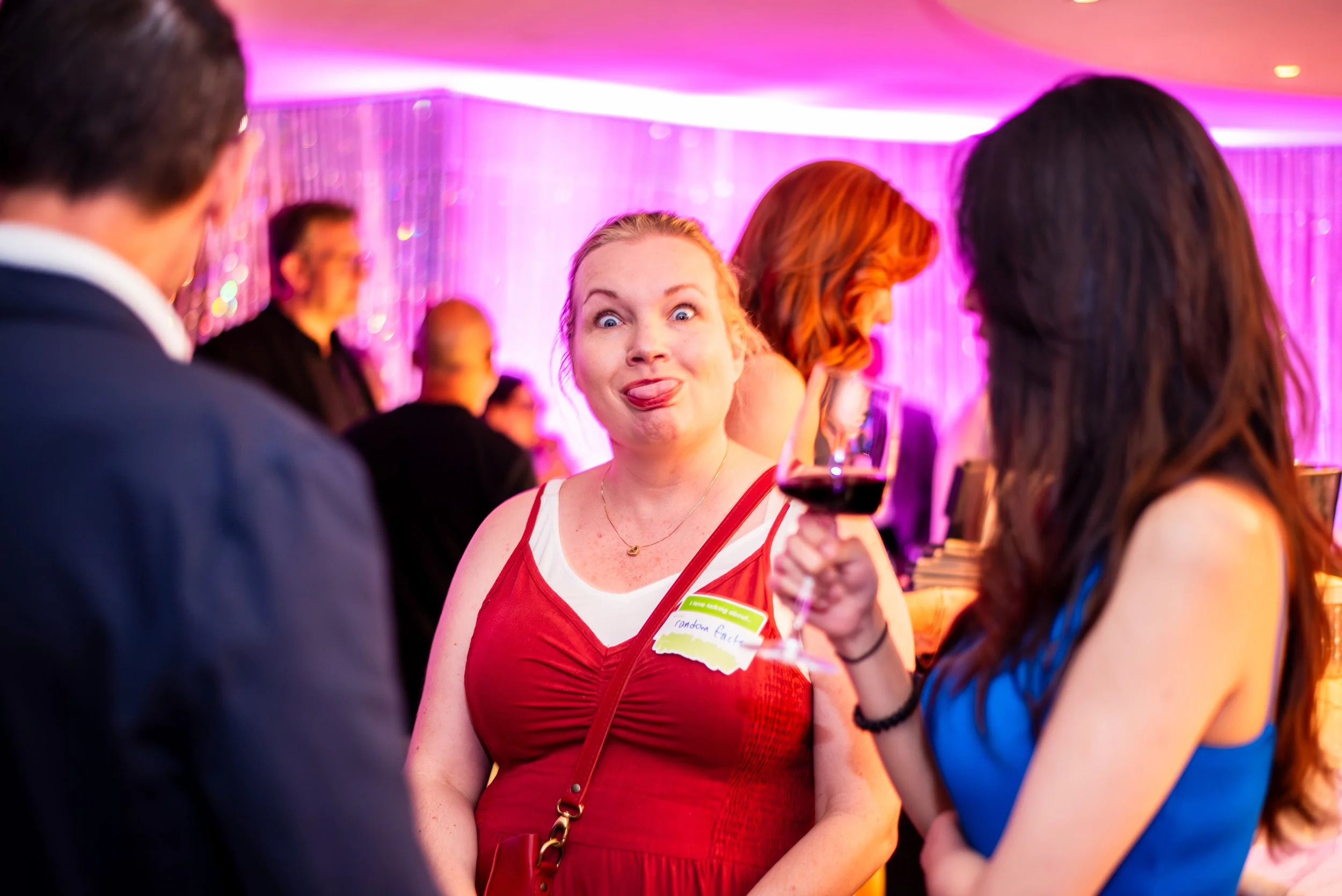 Attendee sticking her tongue out at the ICology Presidents Club Happy Hour at the Chandelier Bar during Transform 2026.