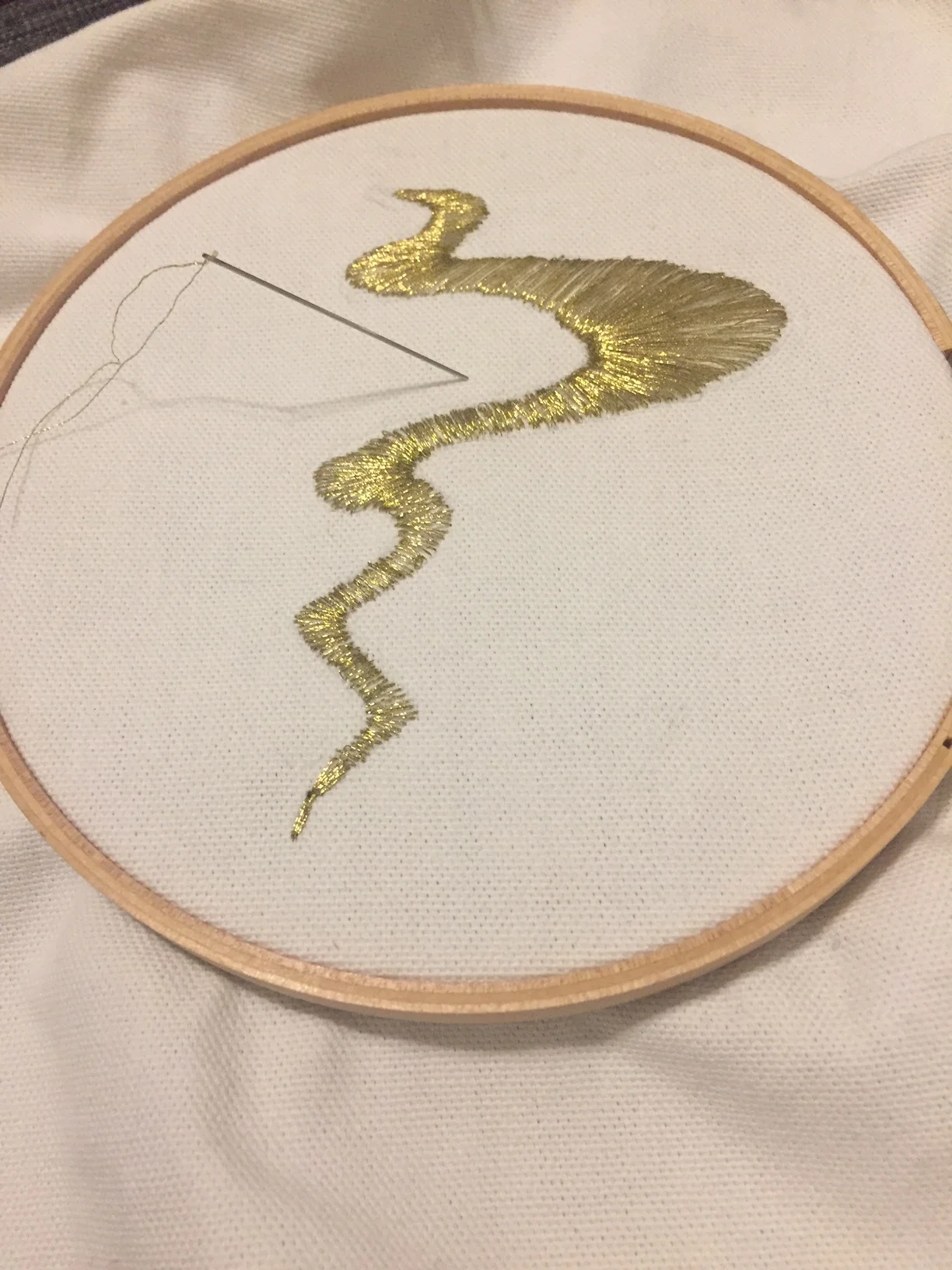 GOLD THREAD ON WHITE CANVAS
