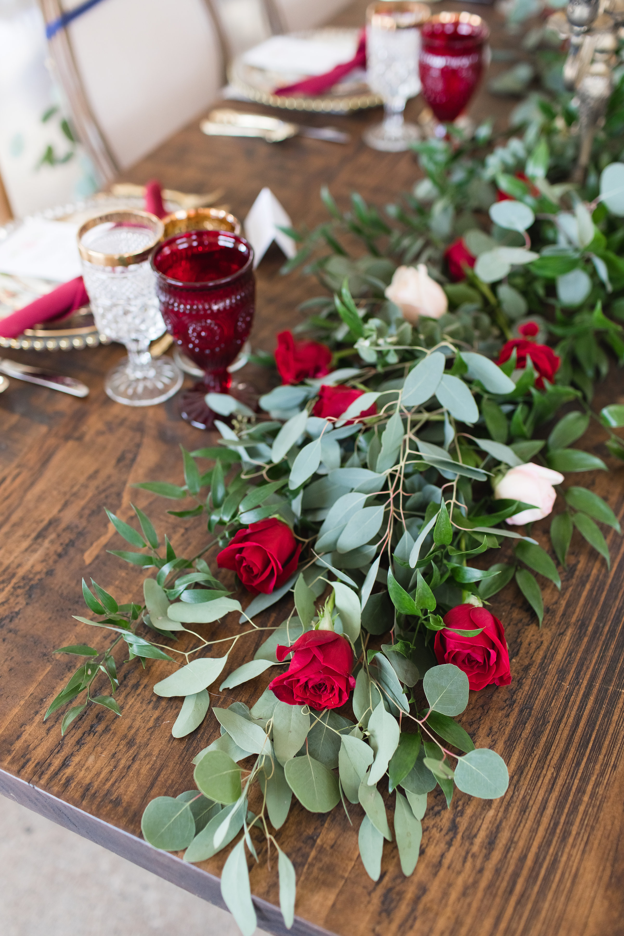  It wouldn't be a Beauty and the Beast Inspired editorial without heaps of lush roses. This gorgeous garland by A Wedding in Silk Floral Design incorporates Italian Ruscus, Eucalyptus, Sweet Olive, Buplurum and Roses. 