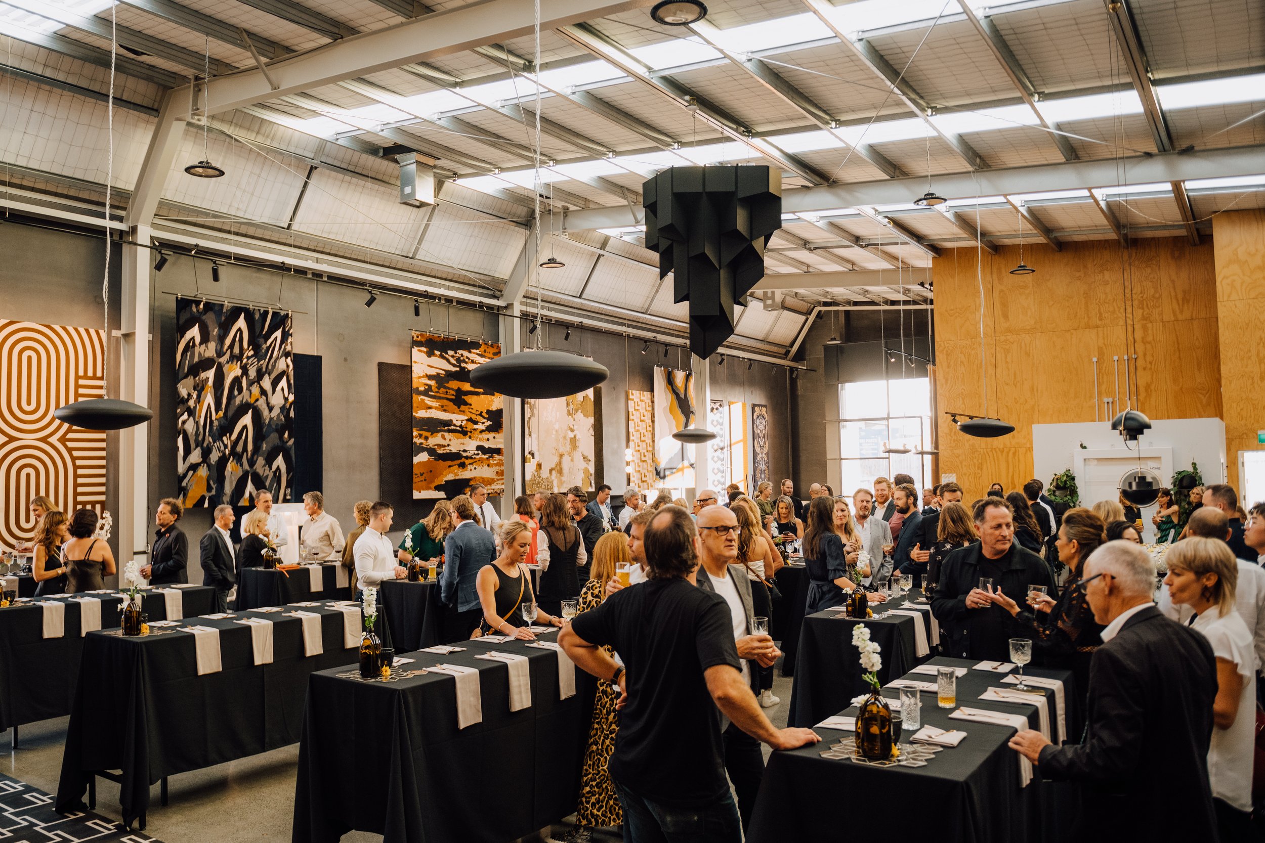 A large crowd attending a slightly formal private event hosting chef Arno's culinary talent several years in a row. Ideal for an event or pop up in an art gallery or exhibition space with stand up food canapes and impeccable 5 star food and service.