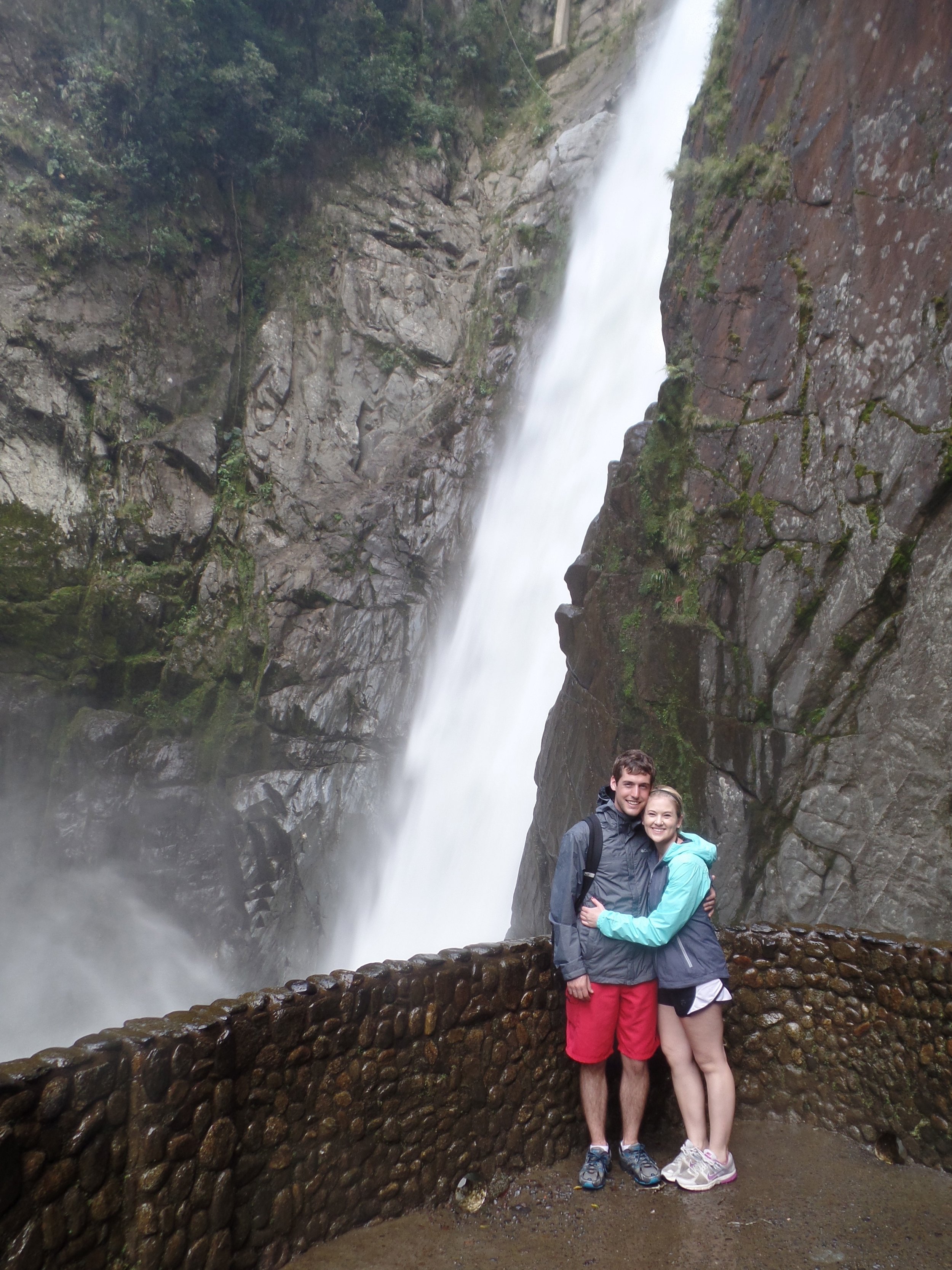 Kayla and Daniel McMullen in front of a waterfall