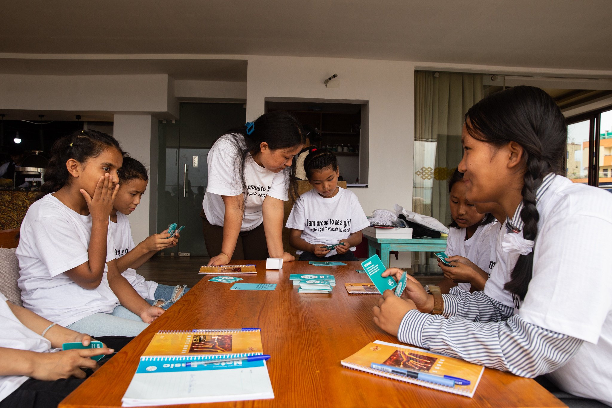  Girls play She’s the First’s What Would You Do? card game to learn about healthy relationships during a mentorship session with The Small World in Kathmandu. (Photo by Uma Bista) 