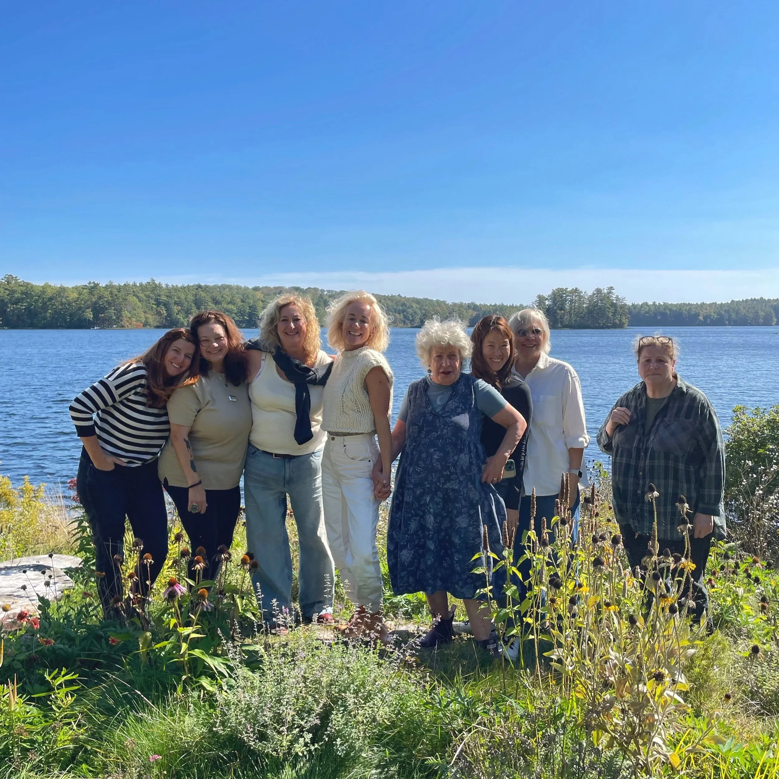 Renowned photographer Cig Harvey stands with her 'Creative Renewal' workshop class, by the sparkling lakefront at Blenheim Park Maine.