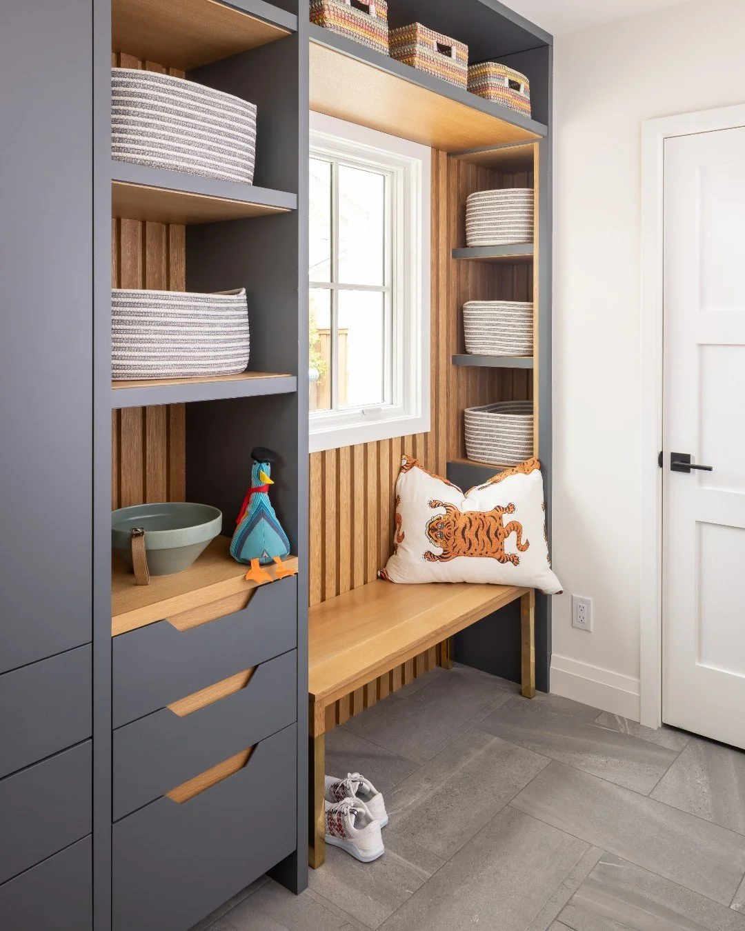 Step into our Fairfax Modern project&rsquo;s renovated mudroom, where custom-built cabinetry seamlessly blends style and functionality. Designed to store jackets, bags, and more, this space acts as a perfect catch-all after a long day. With floor-to-