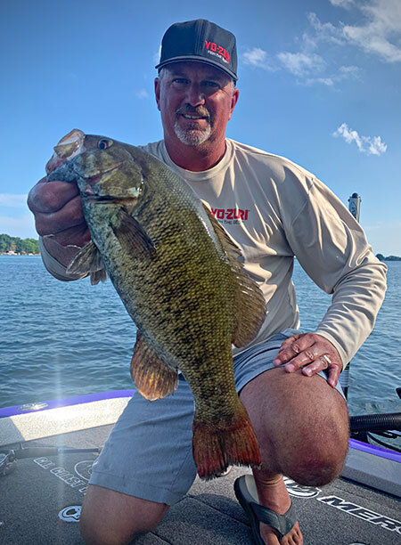 FLW Pro Jimmy Reese with a smallmouth bass