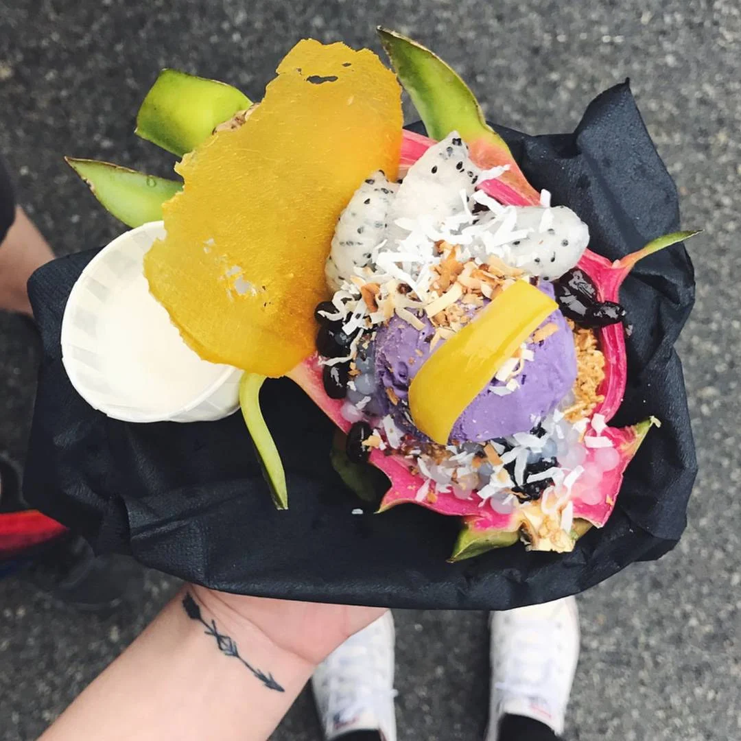 HALO HALO Ube Kitchen Ube ice cream inside a dragonfruit bowl topped with coconut, fruit, and jellies -- can we just let that sink in?!