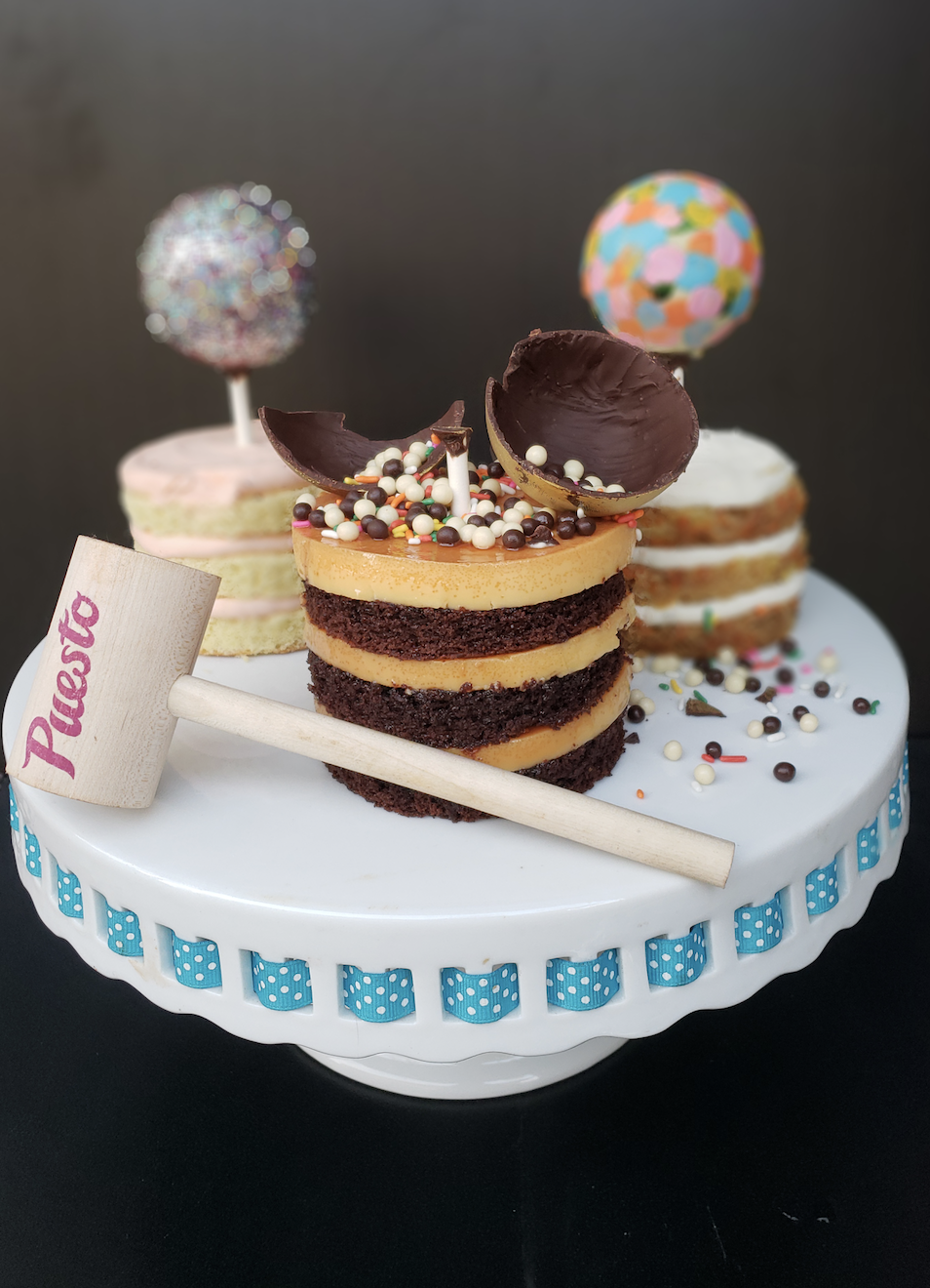  LAYERED PIÑATA CAKES    Puesto    Puesto is debuting their Layered Piñata Cakes--served with hand-painted chocolate "Piñata" spheres and a wooden hammer, so you can break it open and garnish the cake. This is SO EXTRA and we are ALL for it (expect t