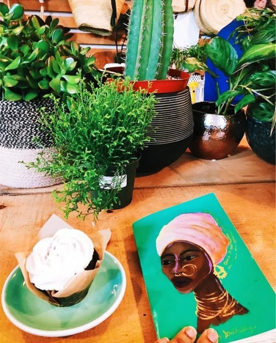 Giselle and her journal at a cafe.