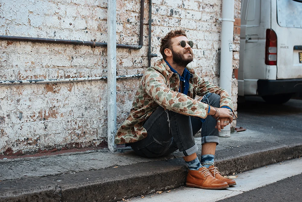 Jules wears the blue bandana , blunt tie and tie-dye socks from his Find Your Magic Collection, available exclusively at The MITT Mrkt . All proceeds from the collection will be made to LYNX ’s charity partner, I-Manifest .