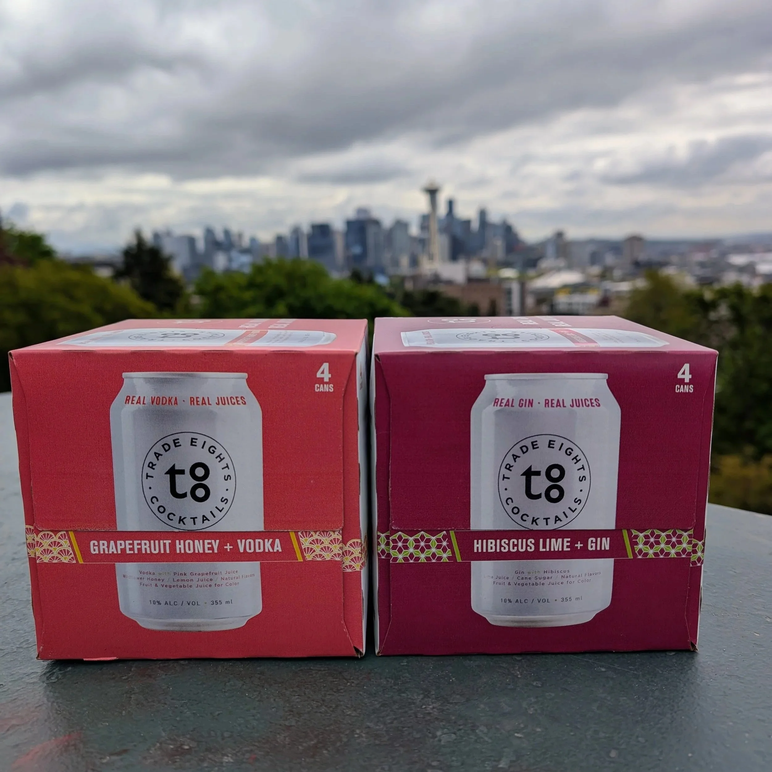 Grapefruit Honey +Vodka 4-Pack in front of Seattle Skyline