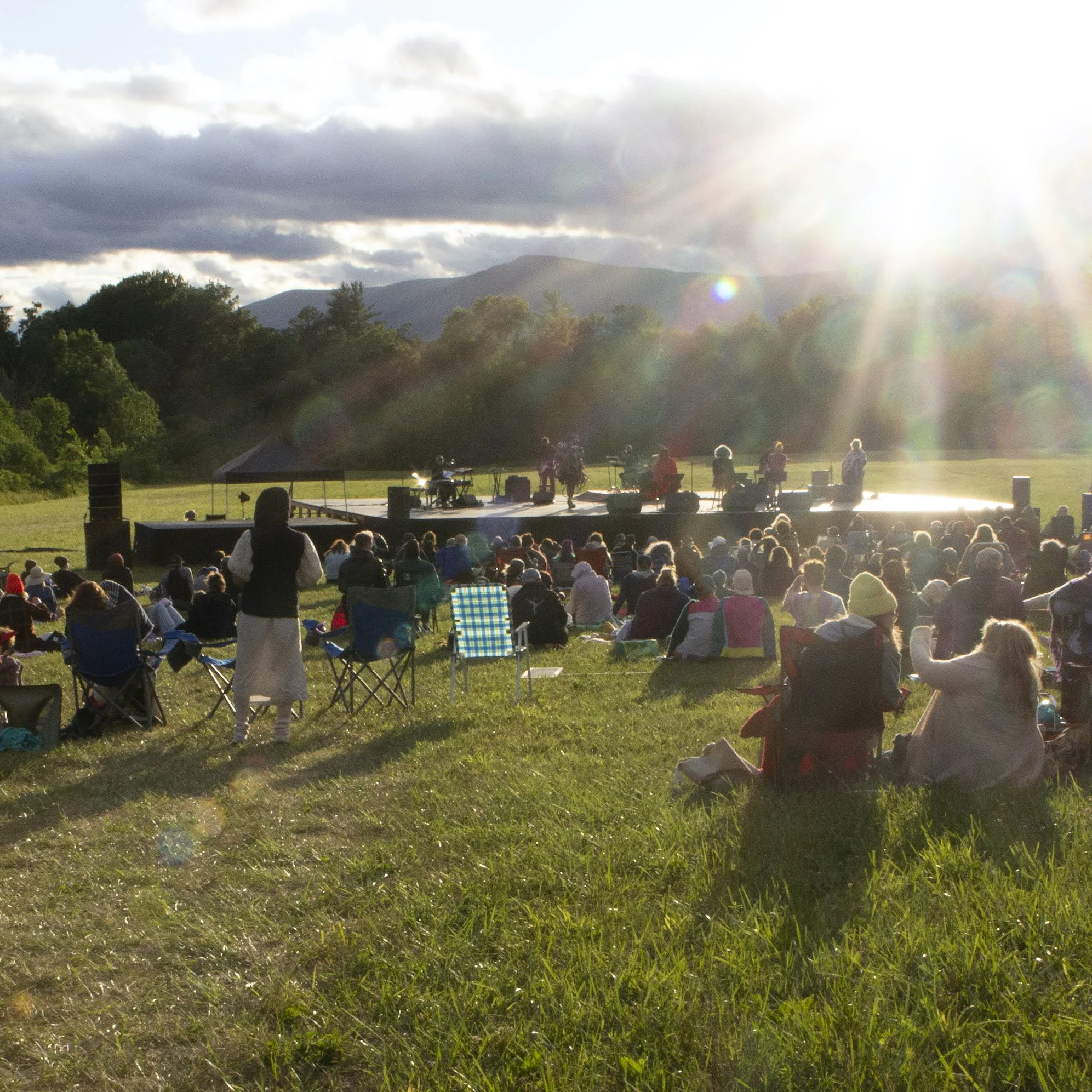 Low sun shines on grounds during performance.