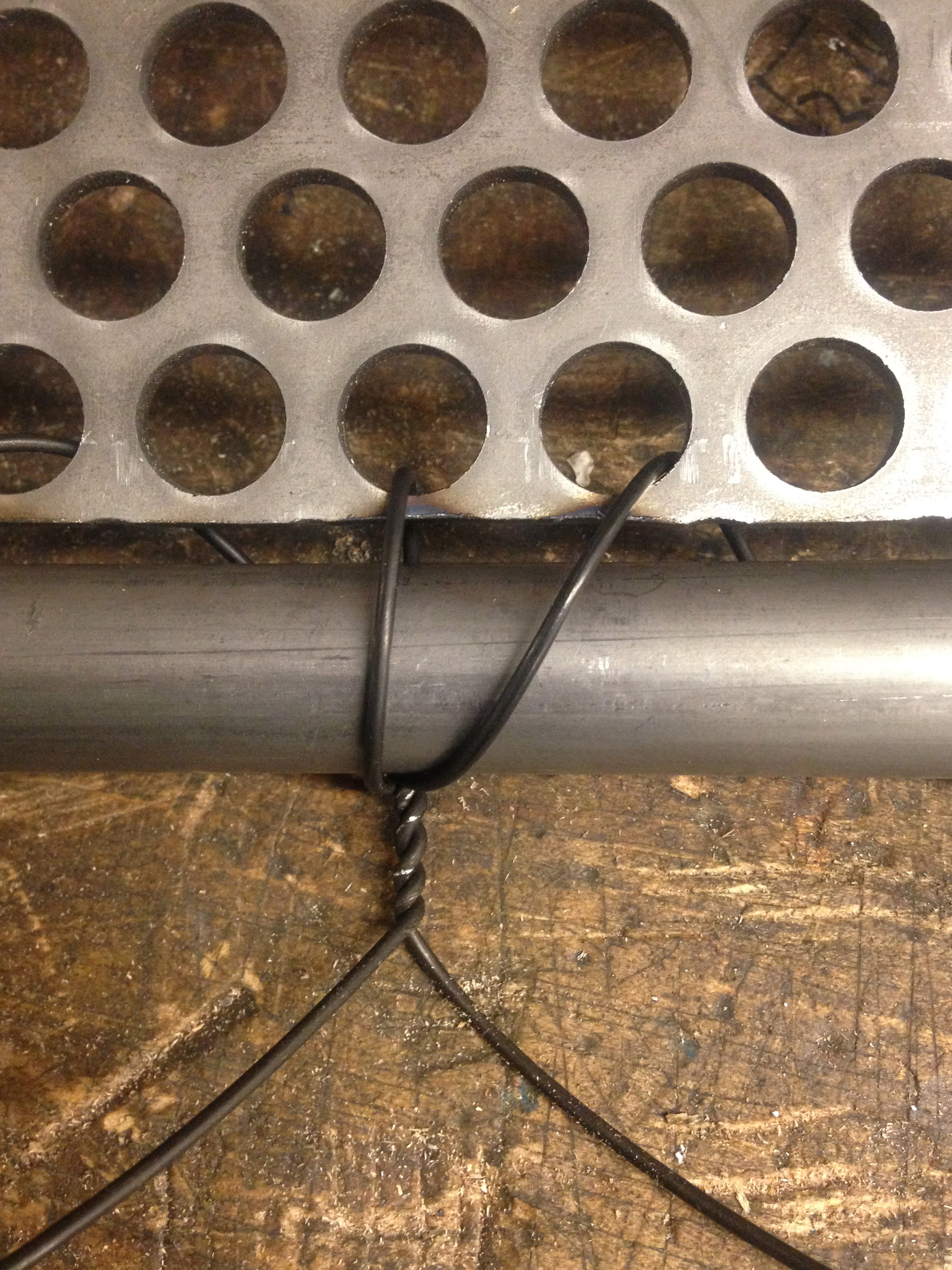 Positioning the perforated sheet before welding the steel tabs