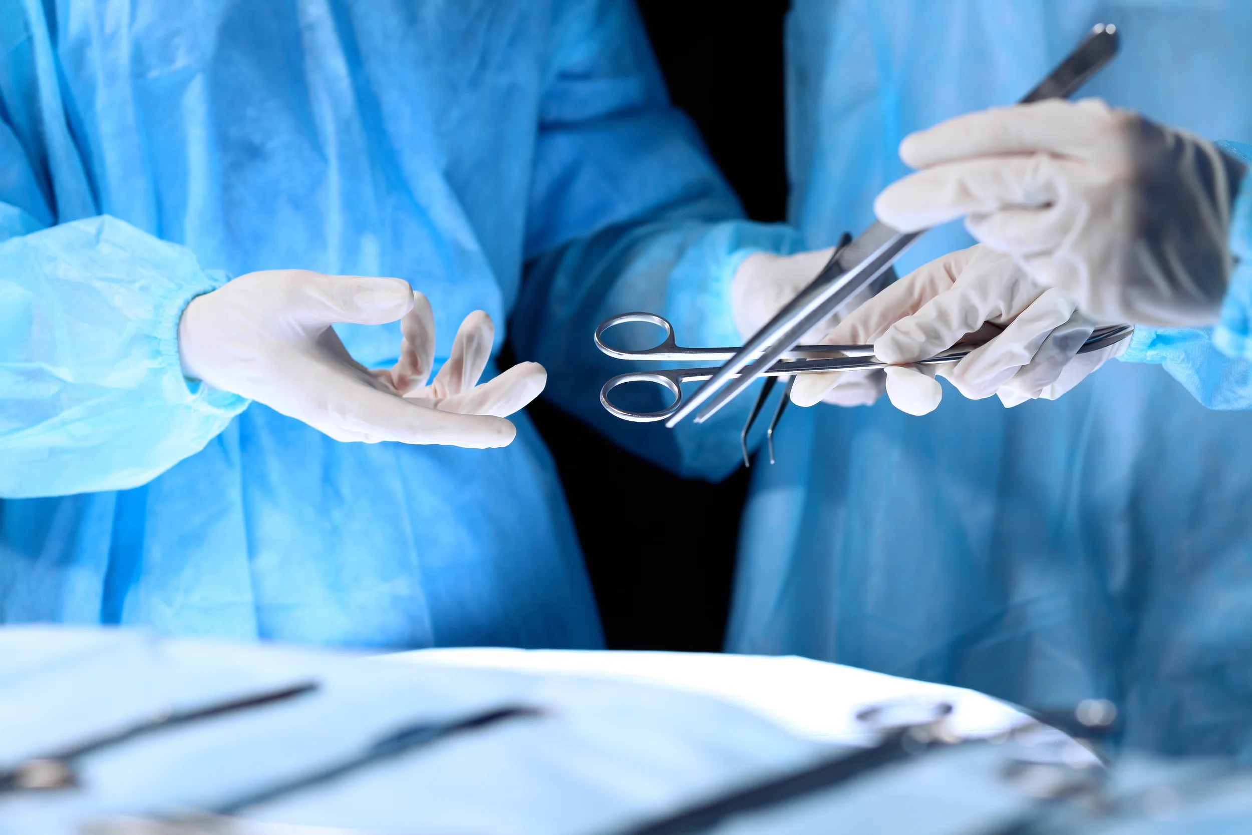 stock-photo-medical-teshutterstockam-performing-operation-group-of-surgeon-is-working-in-operating-theatre-toned-in-blue-457348207.jpg