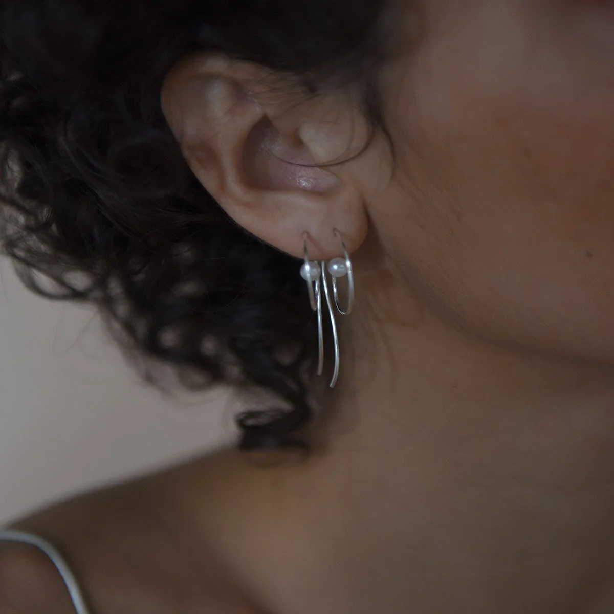 Small_coil_earrings_on_model_for_web_2_1600x.jpg